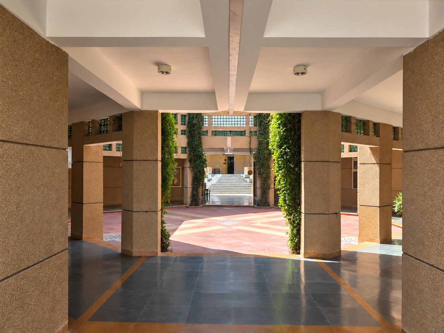 DPS Chhatarpur - corridor opening onto a courtyard, with steps glimpsed beyond