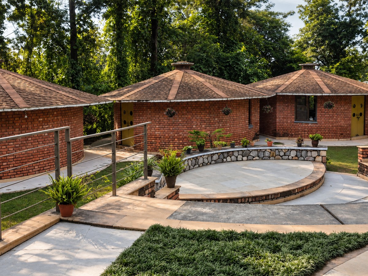 Sidhamshi Village School, Dehradun - circular brick classrooms gathered around a small stone amphitheatre